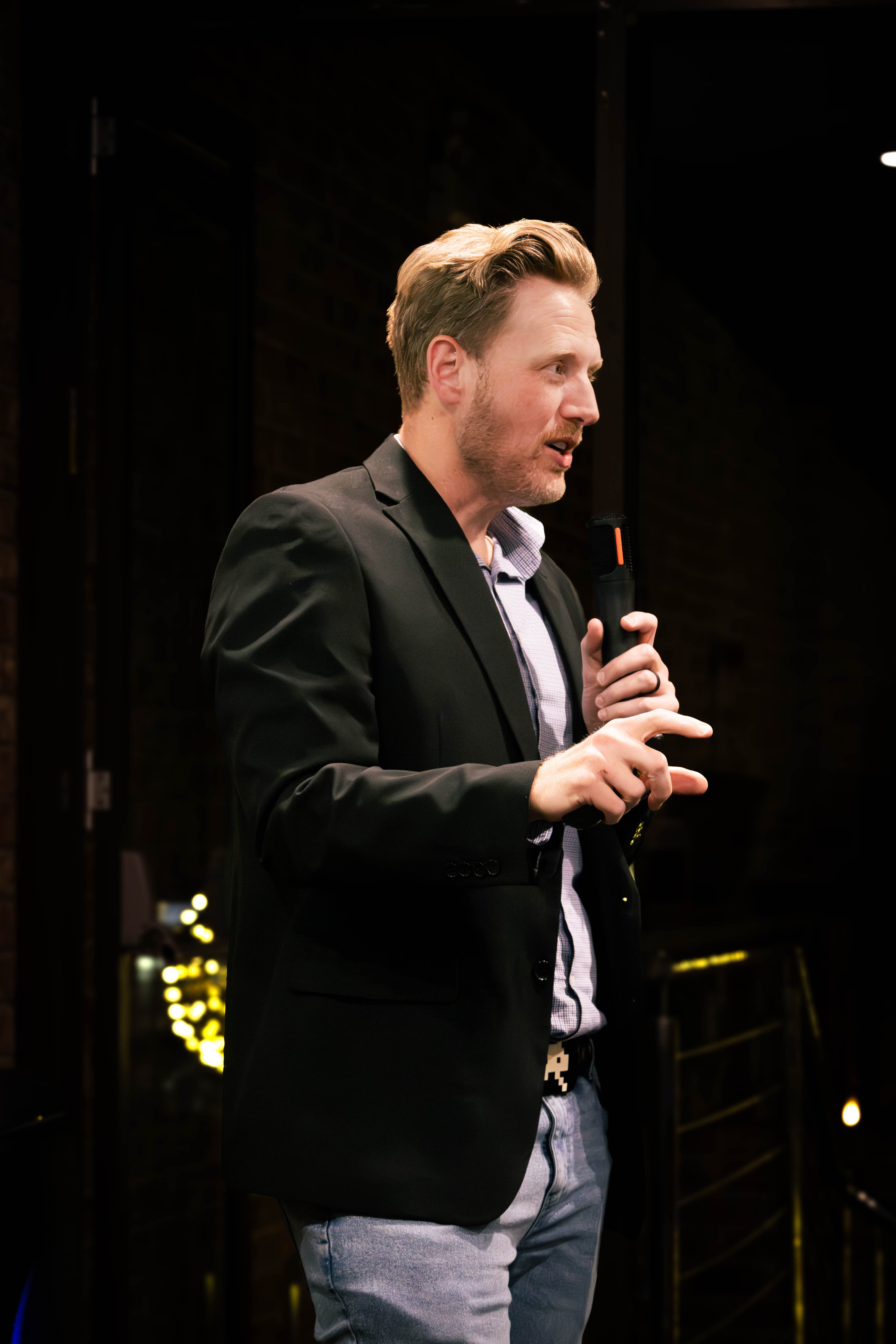 David Pengelley speaking with a microphone at a live event